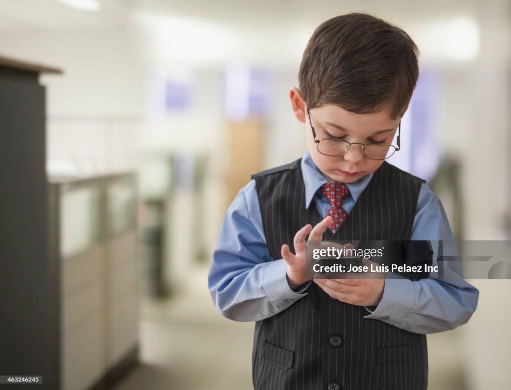 Boy wearing businessman outfit in office