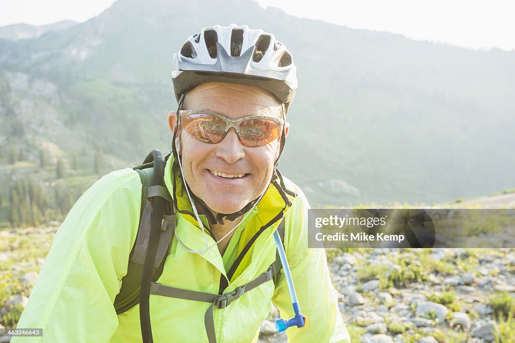 Caucasian man smiling on rocky trail