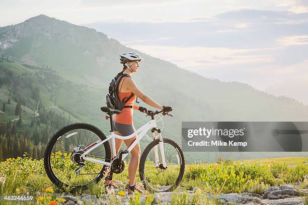 caucasian woman with mountain bike looking at view - alta utah stock pictures, royalty-free photos & images