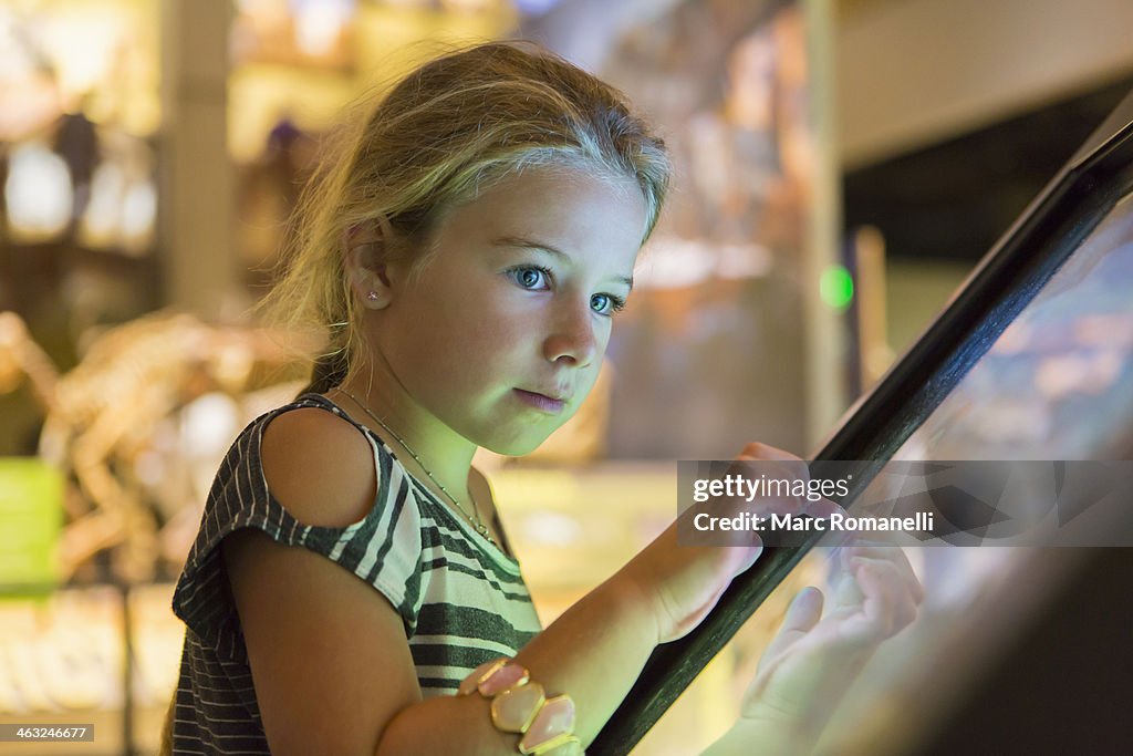 Caucasian girl using touch screen