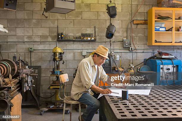 Middle Eastern Man Working In Workshop, Foto de stock