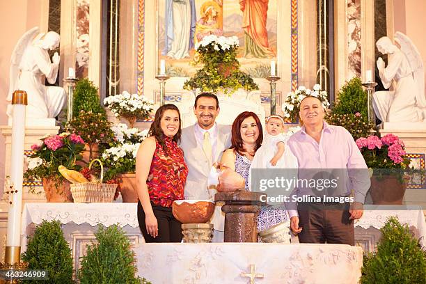 hispanic family smiling by religious relics - godfather godparent stockfoto's en -beelden