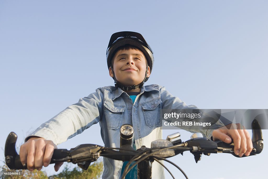 Hispanic boy riding bicycle