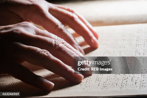 Close up of Hispanic person reading Braille Close up of Hispanic person reading Braille