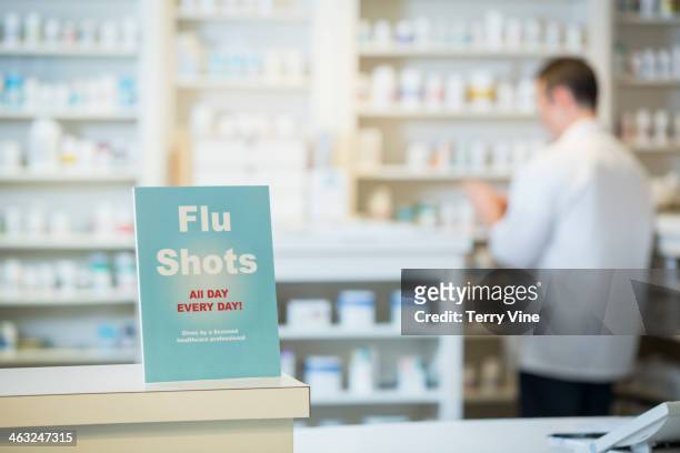 flu shots sign in pharmacy - cajero fotografías e imágenes de stock
