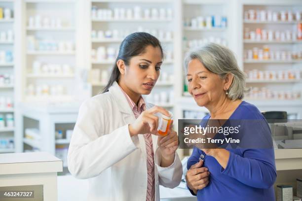 pharmacist talking to customer - prescription medicine stock pictures, royalty-free photos & images