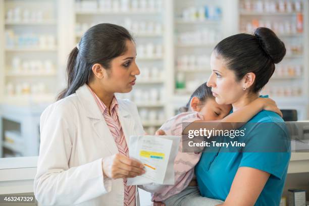 pharmacist talking to customer - houston texas family stock pictures, royalty-free photos & images