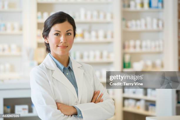 mixed race pharmacist in pharmacy - 女性薬剤師 ストックフォトと画像