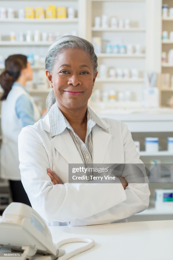 Black pharmacist smiling at counter