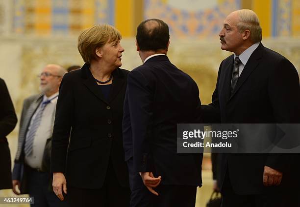 German Chancellor Angela Merkel and French President Francois Hollande leave together after they attend the peace talks over the situation in Eastern...