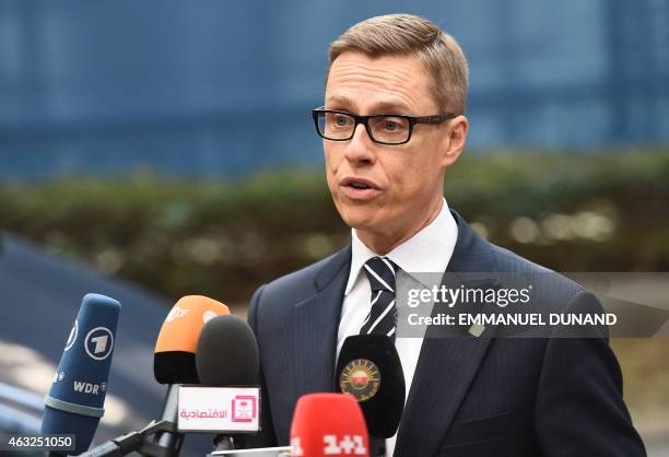 Finnish Prime Minister Alexander Stubb speaks to journalists as he arrives ahead of the European Council Summit at the European Union Headquarters in...