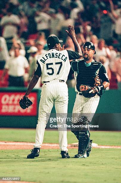 Antonio Alfonseca and Ramon Castro of the Florida Marlins high five during the game against the Arizona Diamondbacks on July 28, 2000 at Pro Player...