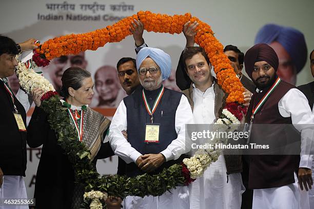 Congress Vice-President Rahul Gandhi, Prime Minister Manmohan Singh and Congress President Sonia Gandhi receive a garland from their party workers...