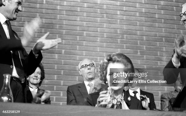 British Prime Minister Margaret Thatcher in Farnborough, UK, circa 1980. Her husband Denis Thatcher is behind.