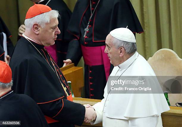 Pope Francis greets German cardinal Gerhard Ludwig Muller before the opening session of the Extraordinary Consistory at the Synod Hall on February...