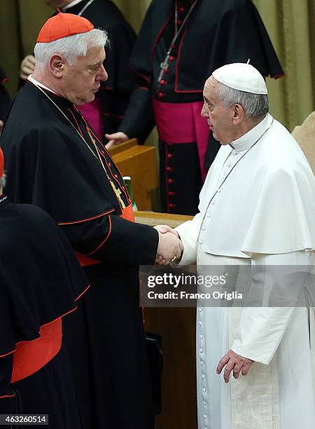 Pope Francis greets German cardinal Gerhard Ludwig Muller before the opening session of the Extraordinary Consistory for the creation of new...