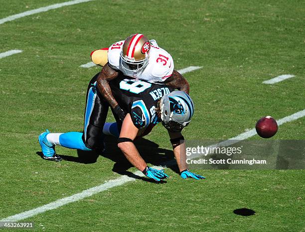 Donte Whitner of the San Francisco 49ers breaks up a pass during the NFC Divisional Playoff Game against Greg Olsen of the Carolina Panthers at Bank...