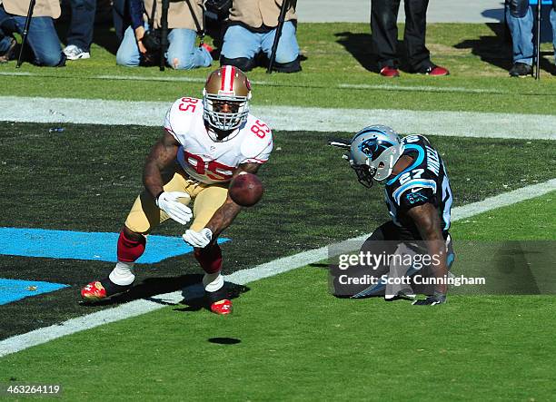 Vernon Davis of the San Francisco 49ers is unable to make a catch during the NFC Divisional Playoff Game against Quintin Mikell of the Carolina...