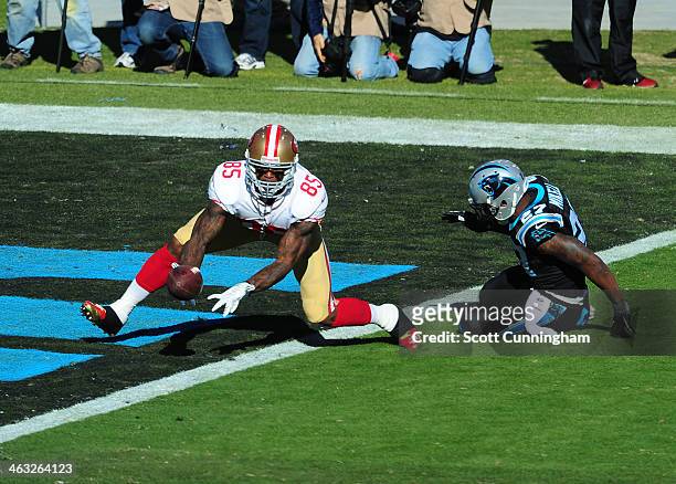 Vernon Davis of the San Francisco 49ers is unable to make a catch during the NFC Divisional Playoff Game against Quintin Mikell of the Carolina...