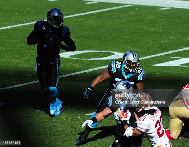 Cam Newton of the Carolina Panthers passes behind blocking by Mike Tolbert during the NFC Divisional Playoff Game against the San Francisco 49ers at...
