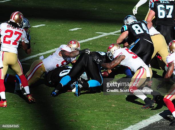 Mike Tolbert of the Carolina Panthers is tackled during the NFC Divisional Playoff Game by NoVorro Bowman and Ahmad Brooks of the San Francisco 49ers...