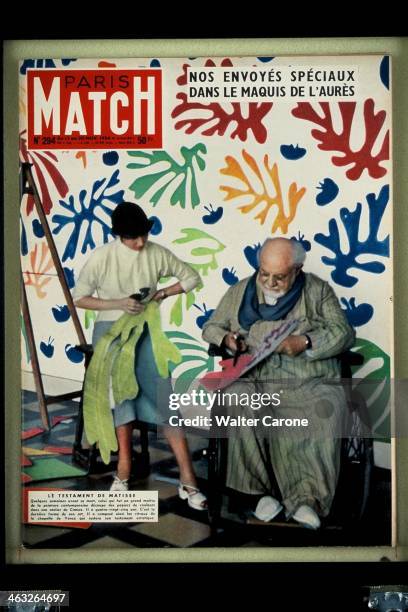 The cover of 'Paris Match' magazine No.294, from the 13th-20th November 1954: French artist Henri Matisse and his assistant creating découpage...