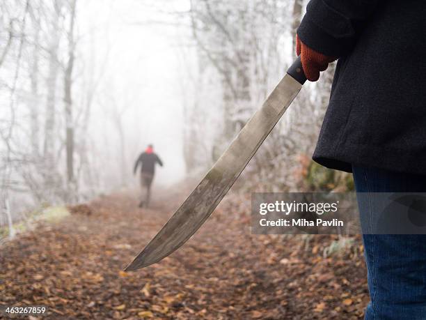 woman with machete chasing man - machete stock-fotos und bilder