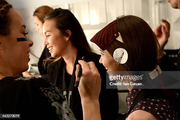 Model is getting styled backstage ahead of the Marina Hoermanseder show during Mercedes-Benz Fashion Week Autumn/Winter 2014/15 at Brandenburg Gate...