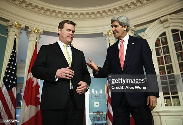 Secretary of State John Kerry and Canadian Foreign Minister John Baird shake hands after they spoke to the press prior to a bilateral meeting January...