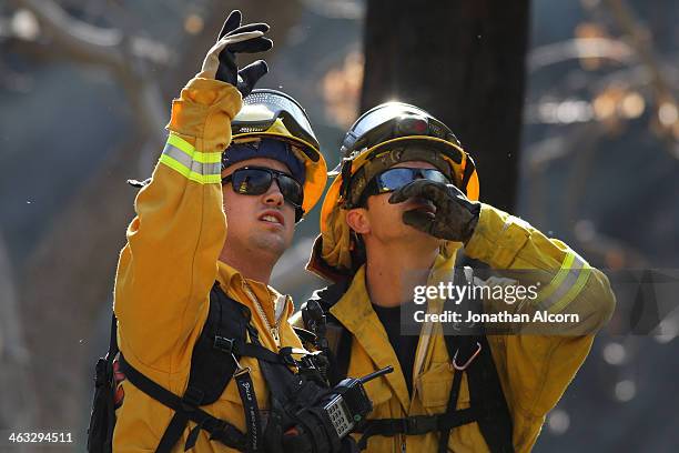 Cal Fire crew work at a flare-up at the Colby Fire burning for a second day in the hillside above Highway 39 on January 17, 2014 in Azusa,...