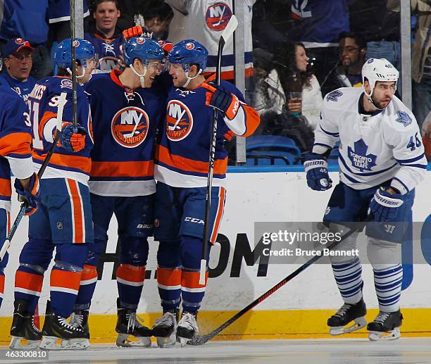 John Tavares, Anders Lee and Josh Bailey of the New York Islanders celebrate a first period goal by Lee against the Toronto Maple Leafs at the Nassau...