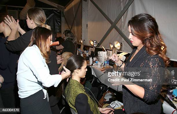 Model prepares backstage at the Tome show during Mercedes-Benz Fashion Week Fall 2015 at The Pavilion at Lincoln Center on February 12, 2015 in New...