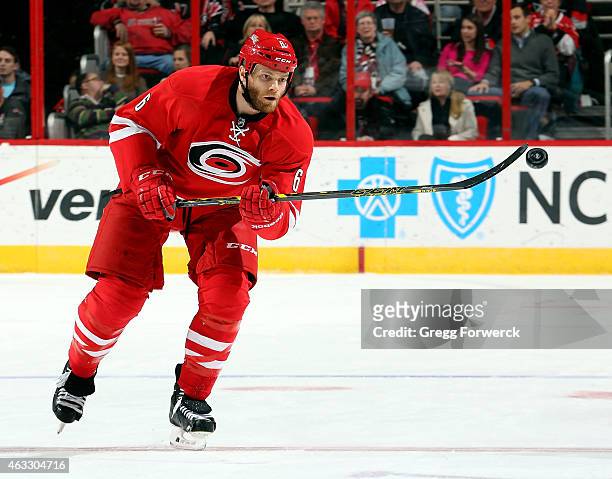 Tim Gleason of the Carolina Hurricanes bats down an errant puck during an NHL game against the Anaheim Ducks during at PNC Arena on February 12, 2015...