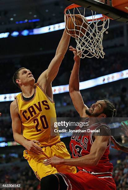 Timofey Mozgov of the Cleveland Cavaliers dunks on Joakim Noah of the Chicago Bulls at United Center on February 12, 2015 in Chicago, Illinois. NOTE...