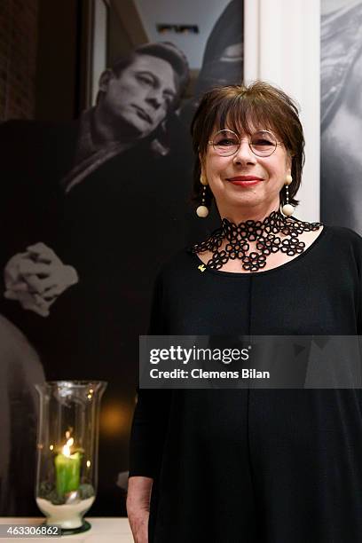 Monika Hansen poses in front of a picture showing Otto Sander at the Warm-Up at the Glashuette Original lounge during the 65th Berlinale...
