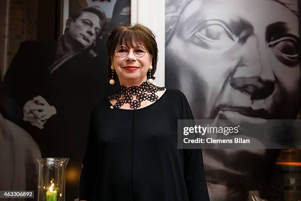 Monika Hansen poses in front of a picture showing Otto Sander at the Warm-Up at the Glashuette Original lounge during the 65th Berlinale...