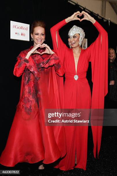 Valerie Jean Garduno and Irina Pantaeva pose backstage at the Go Red For Women Red Dress Collection 2015 presented by Macy's fashion show during...