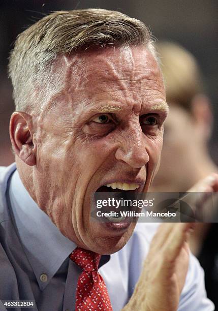 Head coach Mike Dunlap of the Loyola Marymount Lions huddles with his players during a timeout in the first half against the Gonzaga Bulldogs at...