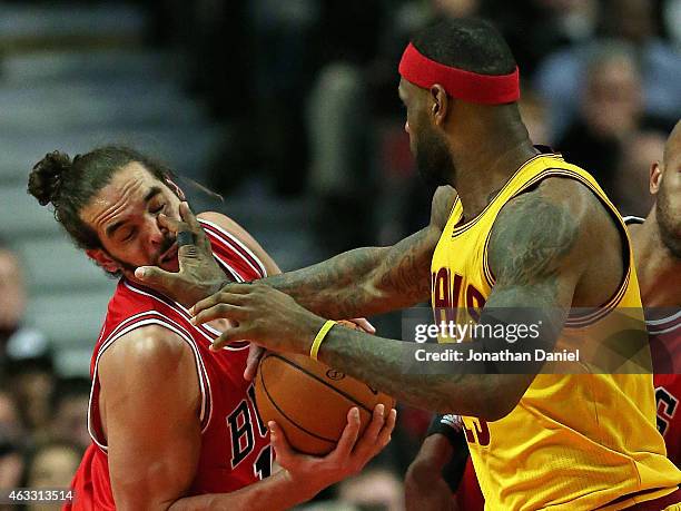 LeBron James of the Cleveland Cavaliers fouls Joakim Noah of the Chicago Bulls at the United Center on February 12, 2015 in Chicago, Illinois. The...