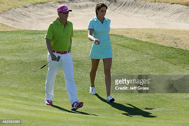 Jonas Blixt of Sweden and Holly Sonders walk together on the ninth green of the Jack Nicklaus Private Course at PGA West during the second round of...