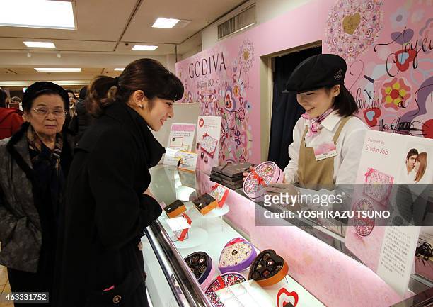 Women buy boxes of chocolates as gifts before Valentine's Day at Tokyo's Mitsukoshi department store on February 13, 2015. Japanese women jostled...
