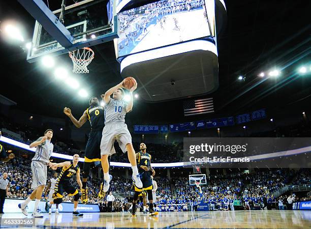 Grant Gibbs of the Creighton Bluejays drives against Jamil Wilson of the Marquette Golden Eagles during their game at the CenturyLink Center on...