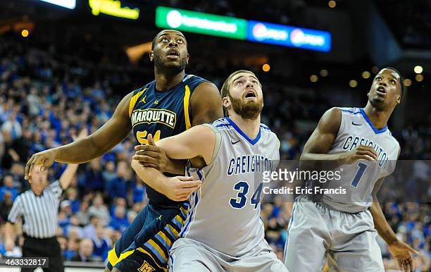 Ethan Wragge of the Creighton Bluejays holds off Davante Gardner of the Marquette Golden Eagles during their game at the CenturyLink Center on...