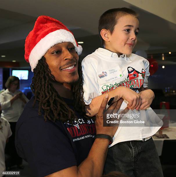 New England Patriots defensive back Marquice Cole gives a lift to Robby Leighton of Rochester, NH at the The New England Patriots Charitable...