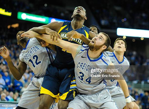 Ethan Wragge of the Creighton Bluejays and Jahenns Manigat of the Creighton Bluejays box out Chris Otule of the Marquette Golden Eagles during their...