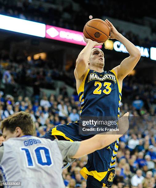 Jake Thomas of the Marquette Golden Eagles shoots over Grant Gibbs of the Creighton Bluejays during their game at the CenturyLink Center on December...