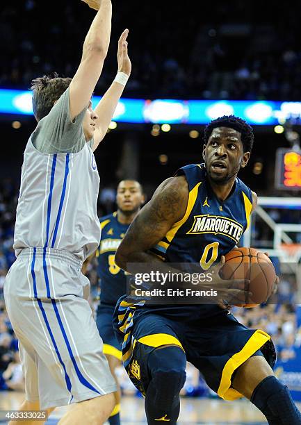 Jamil Wilson of the Marquette Golden Eagles works against Grant Gibbs of the Creighton Bluejays during their game at the CenturyLink Center on...