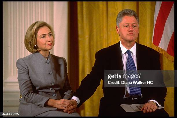January 7, 1998: Pres. Bill Clinton holding hand of wife Hillary are photographed as she gazes upwards during conf. On child care in East Room of...
