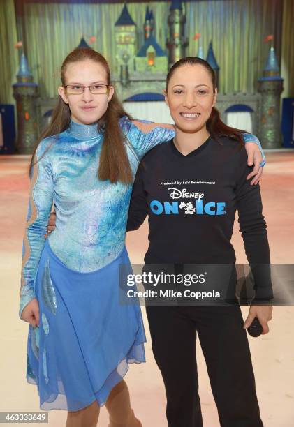 Special Olympian poses for a picture with former Olympian and Disney On Ice cast member Natasha Kuchiki at Prudential Center on January 17, 2014 in...