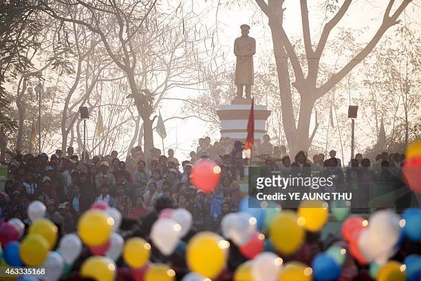 People holding balloons attend a ceremony to mark the 100th birthday of independence hero Aung San, in the remote central Myanmar town of Natmauk on...